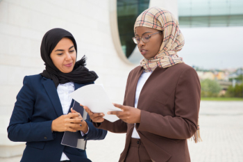 Muslim business women discussing contract text Free Photo Muslim business women discussing contract text Free Photo