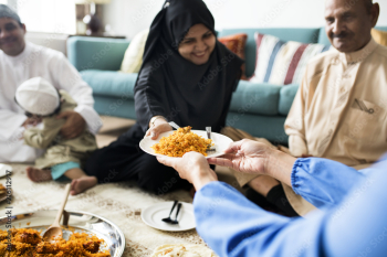 Muslim family having dinner on the floor Muslim family having dinner on the floor