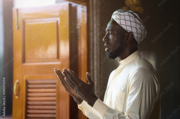 muslim man having worship and praying for allah blessing in islam ceremony in mosque during islamic ramadan period