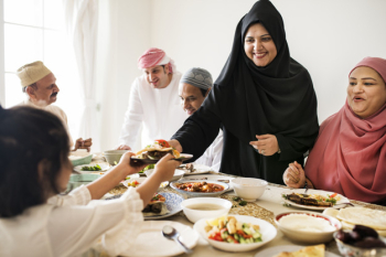 Muslim woman sharing food at Ramadan feast Muslim woman sharing food at Ramadan feast