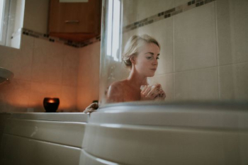 naked woman sitting inside bath tub naked woman sitting inside bath tub
