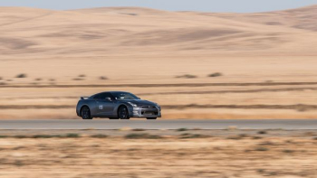 Nissan GTR passing through road on desert Nissan GTR passing through road on desert