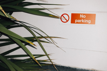 No Parking Sign on White Wall No Parking Sign on White Wall