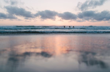 ocean under cloudy sky during sunset ocean under cloudy sky during sunset