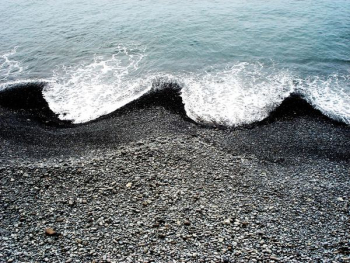 ocean waves hugging black beach sand ocean waves hugging black beach sand