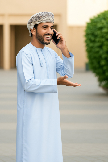 Omani Man Engaged in Mobile Conversation Omani Man Engaged in Mobile Conversation