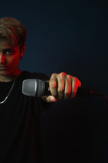 On Stage Performer Holds Out Mic On Stage Performer Holds Out Mic