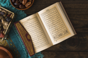 Opened Quran near Arabic desserts Opened Quran near Arabic desserts