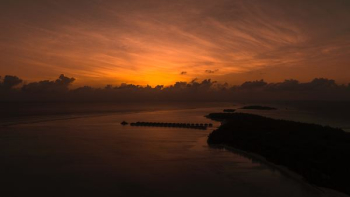 Orange sunset behind Maldives island Orange sunset behind Maldives island