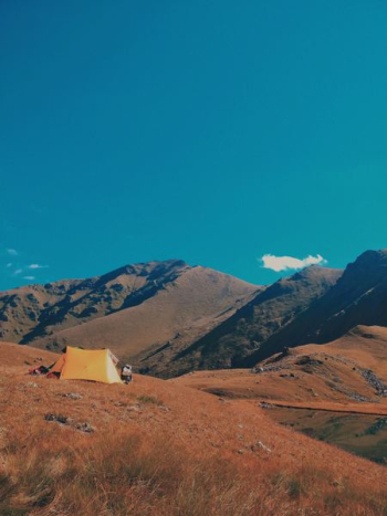 orange tent on mountain orange tent on mountain