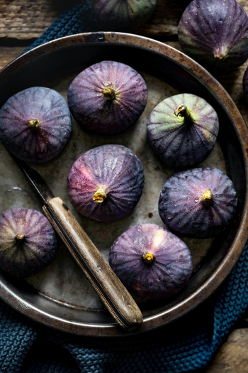 Organic figs fruit ingredient in a plate flat lay Organic figs fruit ingredient in a plate flat lay