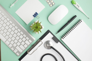 Overhead view of doctor's desk with pills and office supplies Free Photo