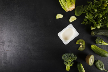 Overhead view of fresh green vegetables on black background