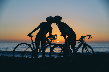 Pair of cyclists reached their destination to see beautiful sunset