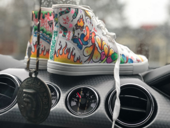 Pair of Multicolored Mid-rise Shoes on Black Car Air Vents Pair of Multicolored Mid-rise Shoes on Black Car Air Vents