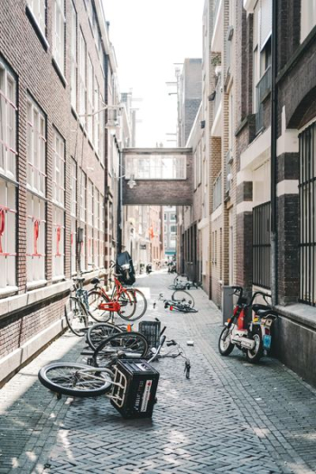 parked bicycles between concrete buildings parked bicycles between concrete buildings