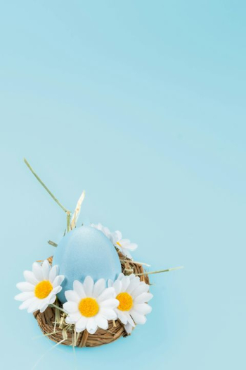 Pastel Blue Easter Egg in Floral Nest Pastel Blue Easter Egg in Floral Nest