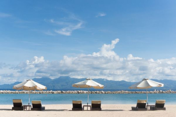 patio umbrella and lounger chair overlooking the sea patio umbrella and lounger chair overlooking the sea