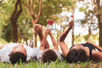 People Lying on thre Grass Holding Up andy People Lying on thre Grass Holding Up andy