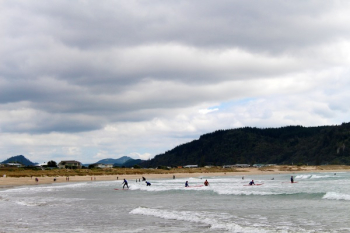 People on Beach Under Grey Cloudy Sky People on Beach Under Grey Cloudy Sky