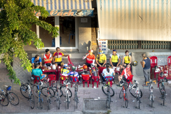 People Sitting Near Bicycles People Sitting Near Bicycles