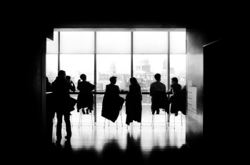 people sitting on chairs people sitting on chairs