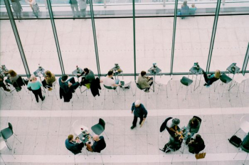 people sitting on chairs near tables during daytime people sitting on chairs near tables during daytime