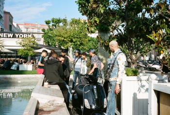 People Standing Beside Black Motor Scooter People Standing Beside Black Motor Scooter