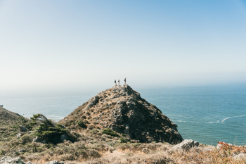 People Standing on Cliff Edge