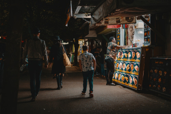 People Walking Beside Food Stall People Walking Beside Food Stall
