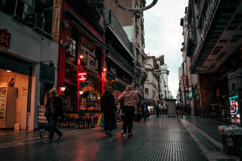 People Walking On Alley Near Buildings People Walking On Alley Near Buildings