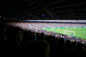 people watching football at stadium during daytime people watching football at stadium during daytime