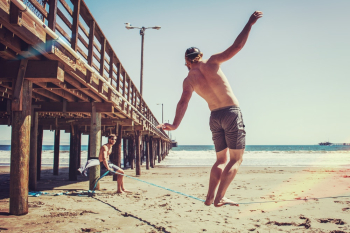 Person Balancing On Blue Rope