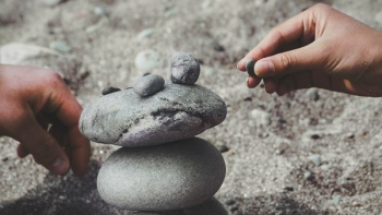 person balancing rocks person balancing rocks