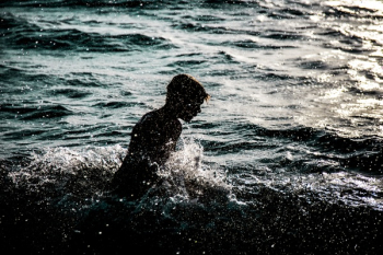 Person Bathing in Body of Water