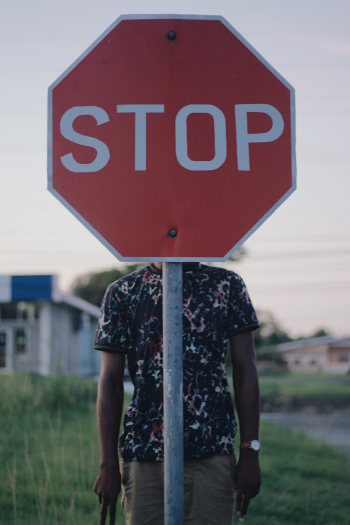 Person Behind Stop Signage Person Behind Stop Signage