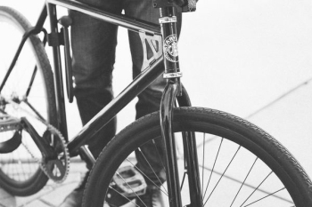 person beside black road bike person beside black road bike