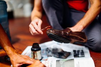 Person Brushing Brown Dress Shoe Person Brushing Brown Dress Shoe