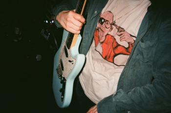 Person Carrying Blue Electric Guitar Person Carrying Blue Electric Guitar