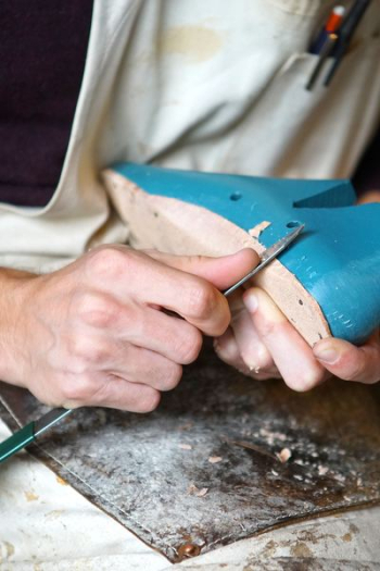 person carving blue footwear person carving blue footwear