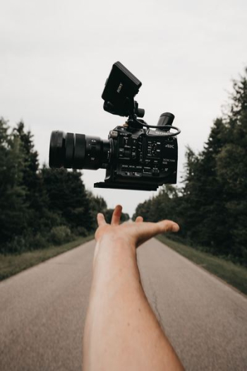 person catching black Sony camcorder person catching black Sony camcorder