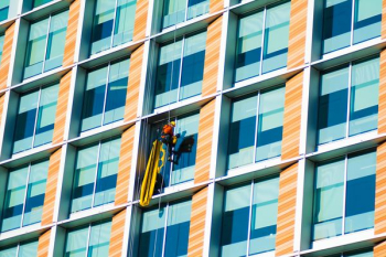 person climbing on curtain wall building person climbing on curtain wall building