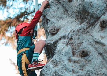 Person Climbing on Gray Rock Person Climbing on Gray Rock