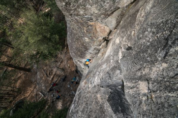 person climbing on gray rock formation at daytime person climbing on gray rock formation at daytime