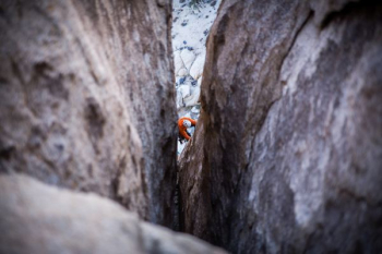 person climbing on rock during daytime person climbing on rock during daytime