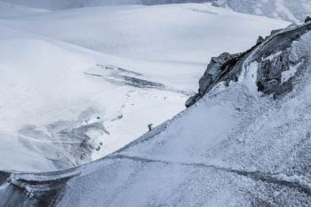 person climbing on top of mountain person climbing on top of mountain