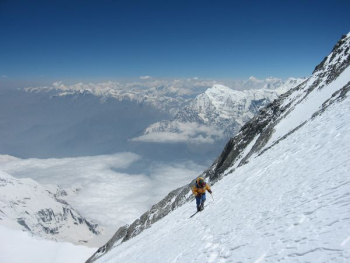 person climbing snow-covered mountain during daytime person climbing snow-covered mountain during daytime