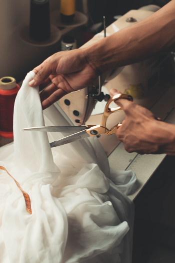 Person Cutting White Cloth Person Cutting White Cloth