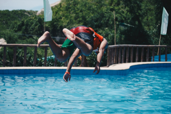 Person Diving on Pool Mid Air Person Diving on Pool Mid Air