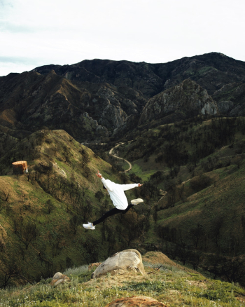 Person Doing Jump Shot Overlooking Mountain Person Doing Jump Shot Overlooking Mountain
